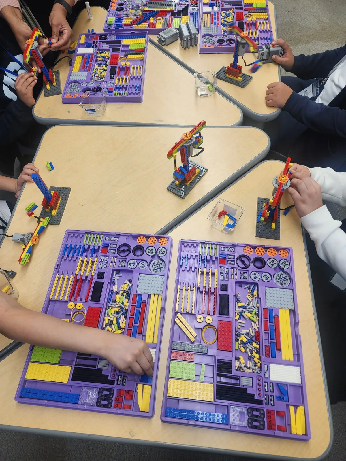 Students using a colorful board game during a practical learning exercise