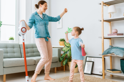 Happy child cleaning room